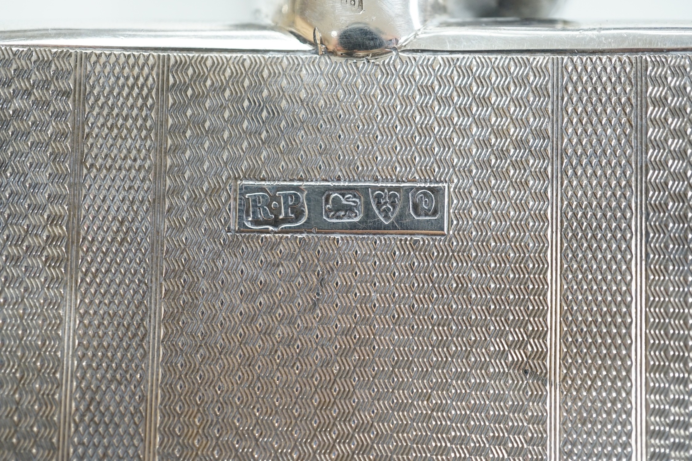 A George V engine turned silver hip flask, by Robert Pringle & Sons, Chester, 1929, 12.8cm and an earlier silver mounted glass hip flask, London, 1910.